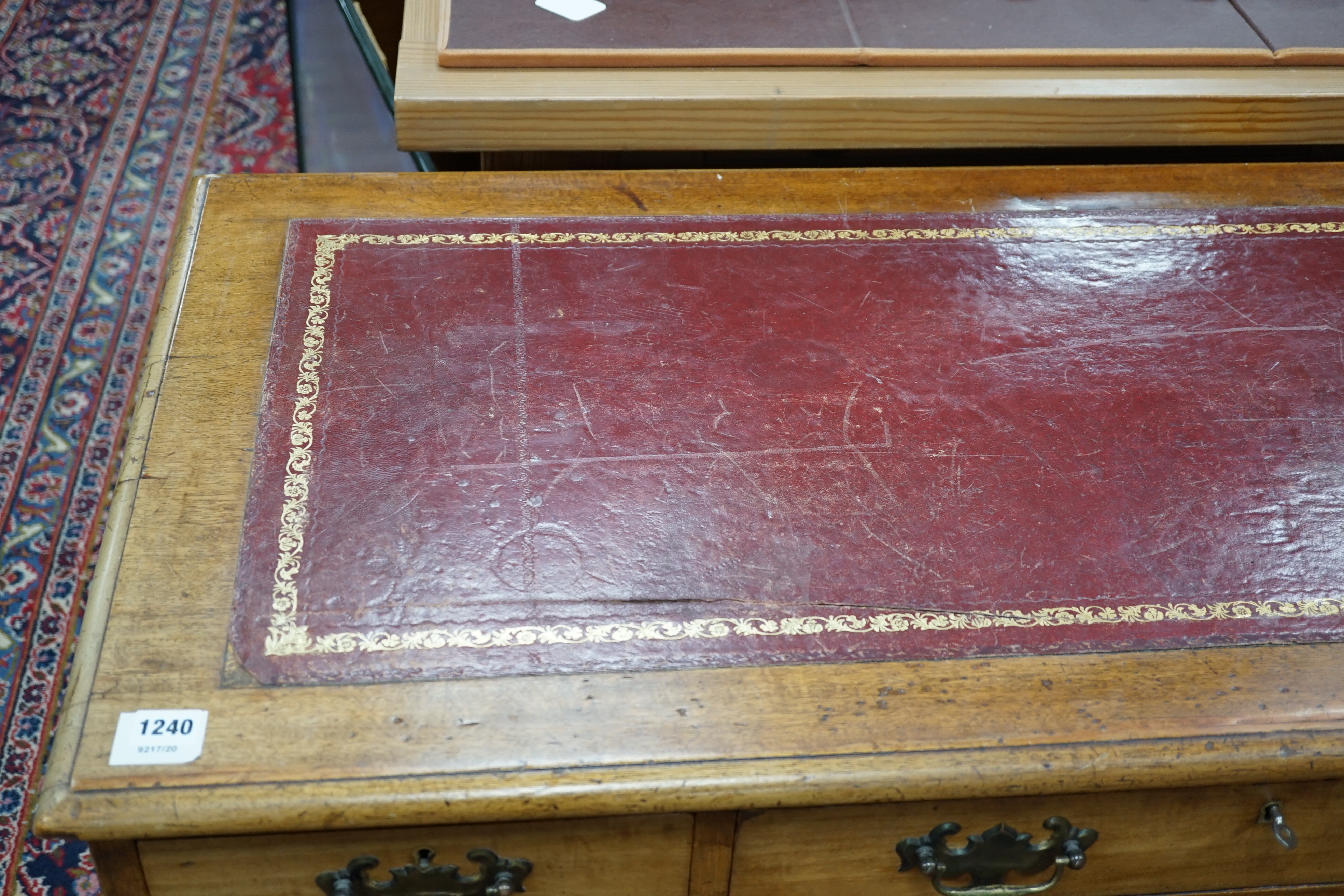 An Edwardian walnut leather-topped pedestal desk, width 120cm, height 72cm